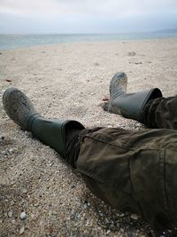 Low section of man resting on beach