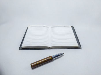 High angle view of pen on table against white background