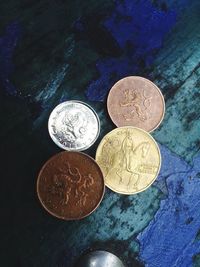 High angle view of coins on metal