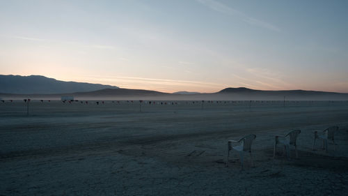 Scenic view of beach against sky during sunset