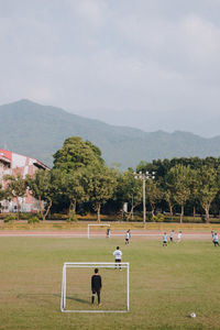 High angle view of men playing soccer on land