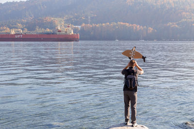 Rear view of man standing in sea