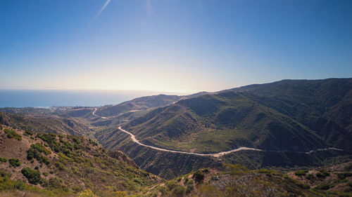 Scenic view of mountains against clear blue sky