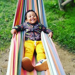Portrait of smiling boy relaxing on hammock