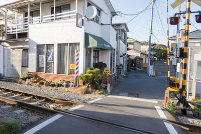 Railroad tracks by buildings in city