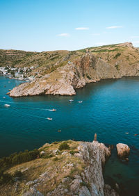 High angle view of rocks on sea shore against sky