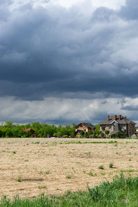 Houses on field against sky