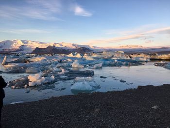Scenic view of glacier against sky during sunset