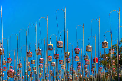 Bird cage hanging on pole against blue sky. contest bird sound tradition in thailand