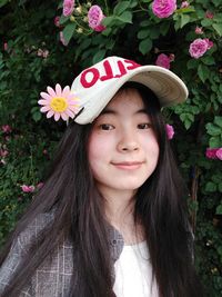 Portrait of smiling young woman wearing cap