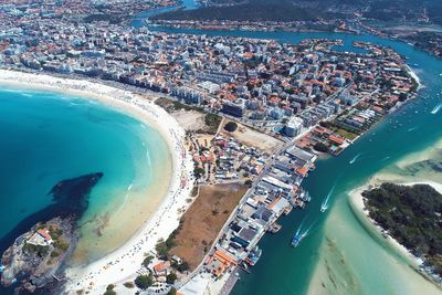 High angle view of crowd on beach against buildings in city