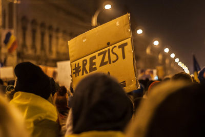 Rear view of people on street at night protesting