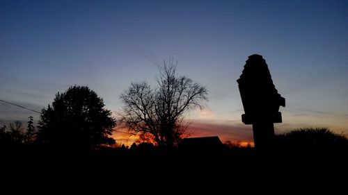 Silhouette trees against sky during sunset