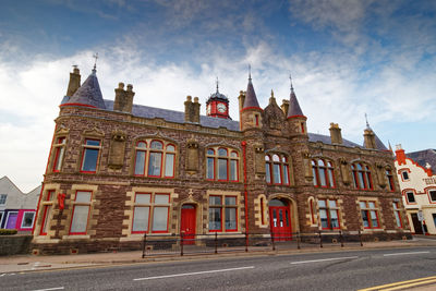 Low angle view of building against cloudy sky