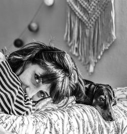 Portrait of woman lying down on bed