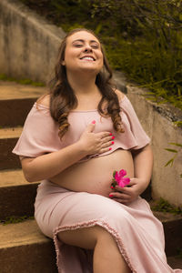 Beautiful young woman sitting outdoors