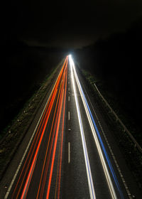 High angle view of light trails on highway at night