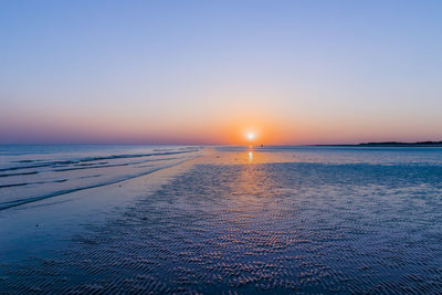 Scenic view of sea against clear sky during sunset