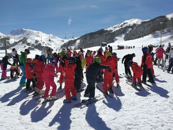 Group of people skiing on snowcapped mountain