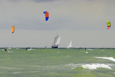 Kite flying over sea against sky