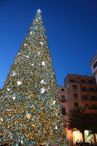 Low angle view of christmas tree against clear sky