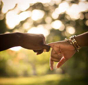 Close-up of couple locking finger