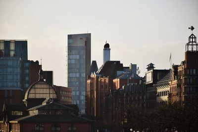 Buildings in city against sky during sunset