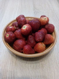 High angle view of strawberries in bowl on table