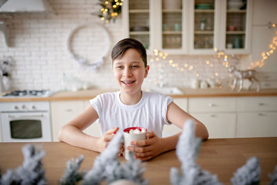 Portrait of smiling boy on table