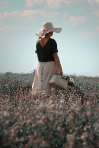 Side view of woman standing on field