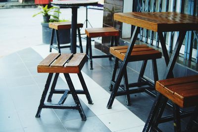 Empty chairs and tables at sidewalk cafe