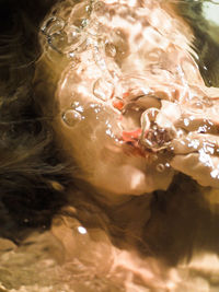 Close-up portrait of woman swimming in sea