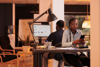 Businesswoman using smart phone at office