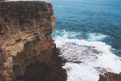 Scenic view of sea by cliff