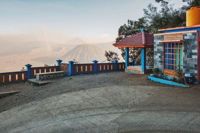 Houses by mountains against sky