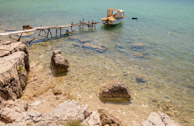 High angle view of rocks on sea shore