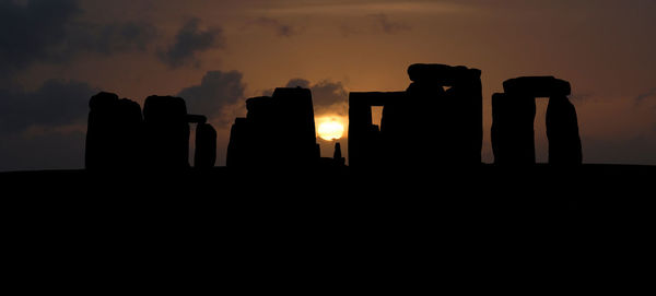 Silhouette temple against sky at sunset