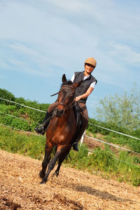 Man riding horse on field