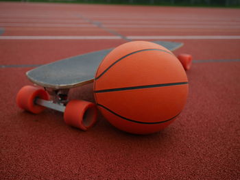 Close-up of basketball and skateboard at park