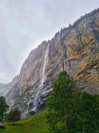 Low angle view of waterfall against sky