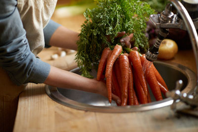 Midsection of woman preparing food on table