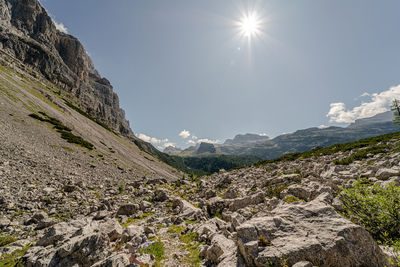 Scenic view of mountains against sky on sunny day