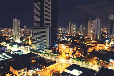 High angle view of city lit up at night