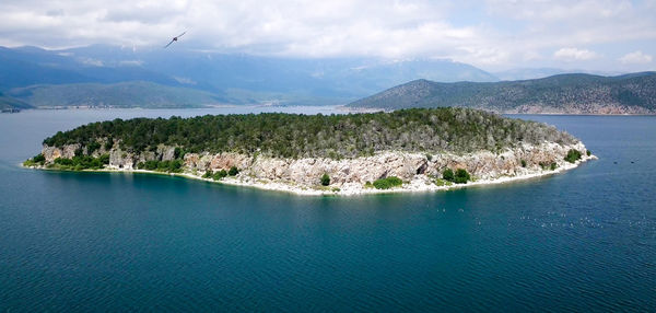 Panoramic view of sea and mountains against sky