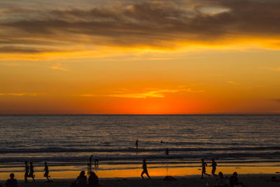 High angle view of silhouette people at beach during sunset