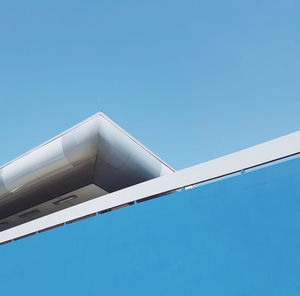 Low angle view of building against clear blue sky