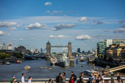 Boats in river with city in background