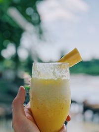Close-up of hand holding drinking glass