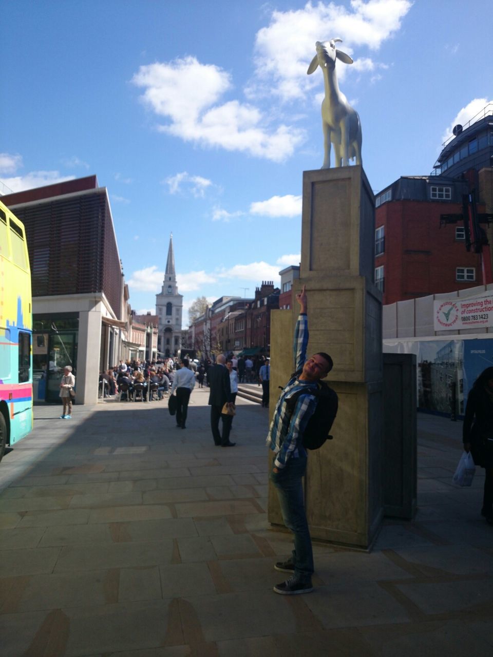 building exterior, street, architecture, men, built structure, animal themes, full length, sky, walking, city, person, lifestyles, city life, rear view, road, transportation, leisure activity, outdoors, sunlight