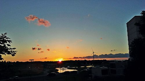 Silhouette city against clear sky during sunset